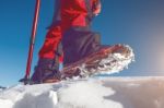 View Of Walking On Snow With Snow Shoes And Shoe Spikes In Winte Stock Photo