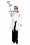 Happy Doctor Posing With Crutches In Hand Stock Photo