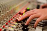 Sound Engineer's Hand Moving On Sound Mixing Board Stock Photo