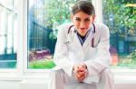 Portrait Of Confident Female Doctor In Lab Coat Stock Photo