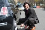 Businessman Repairing Car Roadside Stock Photo