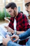 Two Young Entrepreneurs Working At Coffee Shop Stock Photo