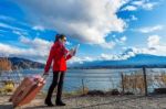 Tourist With Baggage And Map At Fuji Mountain, Kawaguchiko In Japan Stock Photo