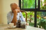 Asian Senior Man Thinking About Something Stock Photo