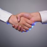 Handshaking Female Hands Stock Photo