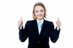 Smiling Girl Gesturing Double Thumbs Up Stock Photo