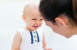 Baby Girl And Her Mother Playing At Home Stock Photo