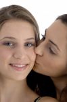 Female Kissing Her Friend Stock Photo