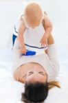 Baby Girl And Her Mother Playing At Home Stock Photo