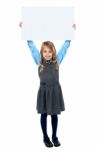 Kid Holding Blank Billboard Above Her Head Stock Photo