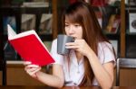 Portrait Of Thai Adult Student University Uniform Beautiful Drinking Coffee Stock Photo