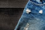 Jeans Lack On The Wooden Floor Stock Photo