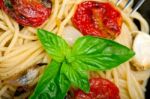 Spaghetti Pasta With Baked Cherry Tomatoes And Basil Stock Photo