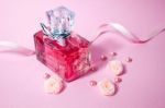 Pink Aromatic Perfume With And Pearls And Roses On Pink Background Stock Photo