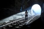 Man Standing In Tunnel Stock Photo