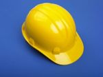 Yello Hard hat On Blue Stock Photo