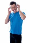 Smiling Guy Holding Headphones Stock Photo