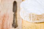 Camembert Cheese And Vintage Knife On Wooden Table Stock Photo