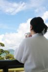 Lady Drinking Coffee In Balcony Stock Photo