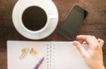 Hot Cup Of Coffee On Wooden Work Table Stock Photo