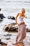 Beautiful Young Blonde Woman Posing Outdoor At The Rocky Sea Sho Stock Photo