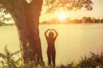 Relax Woman And Sunset Silhouette Stock Photo