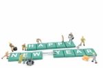 Miniature Worker Team Building Word Happy New Year On White Background Stock Photo