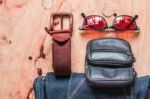 Leather And Jeans On A Wooden Stock Photo