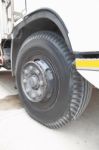 Old Front Wheel Of Truck On Cement Road Stock Photo