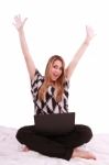 Woman Sitting On Bed With Laptop Stock Photo