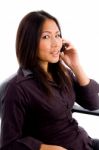 Young Female Service Provider Busy On Cell Phone Stock Photo