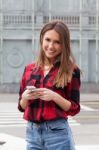 Young Brunette With A Smart Phone Stock Photo