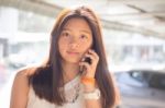 Portrait Of Thai Student Teen Beautiful Girl Using Her Phone And Smile Stock Photo