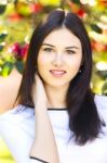 Young Beautiful Woman With Long Straight Dark Hair Posing In Gar Stock Photo