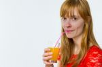 Redhead Girl Drinking Orange Juice Stock Photo