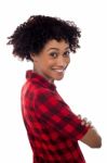 Side Profile Of Slim Young Smiling Woman, Arms Crossed Stock Photo