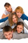 Smiling Teenagers Laying On Floor Stock Photo