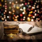 Hot Tea With Notebook And Pen On Wooden Table Stock Photo