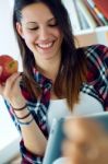 Beautiful Young Woman Using Her Digital Tablet At Home Stock Photo