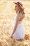 Lonely Beautiful Young Blonde Girl In White Dress With Straw Hat Stock Photo