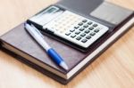 Classic Leather Notebook With Pen And Calculator Stock Photo