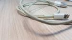 Old Smart Phone Charger Wire On Laminate Floor Stock Photo