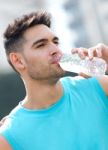 Young Athlete Drinking Water After Exercise Stock Photo