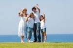 Family of four waving handing Stock Photo