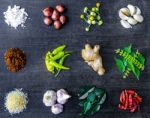 Top View Of Food Ingredients And Condiment On The Table, Ingredients And Seasoning On Dark Wooden Floor Stock Photo