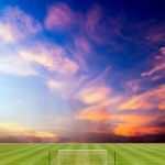 Soccer Field With Beautiful Sunset Background Stock Photo