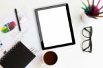 Tablet On Desk Workspace In Office Background Stock Photo