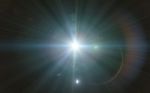 Beautiful Blue Digital Lens Flare In Black Background Horizontal Frame Stock Photo