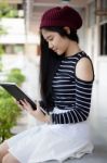 Portrait Of Thai Teen Beautiful Girl Using Her Tablet Stock Photo