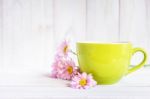 Cup Of Black Coffee And Daisy Flowers On The White Table Stock Photo